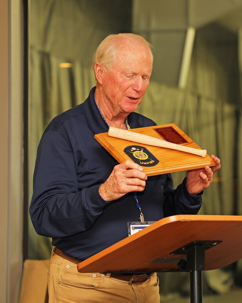 Bob Trevathan looks over Ed McCloskey's plaque before passing it to Ed.